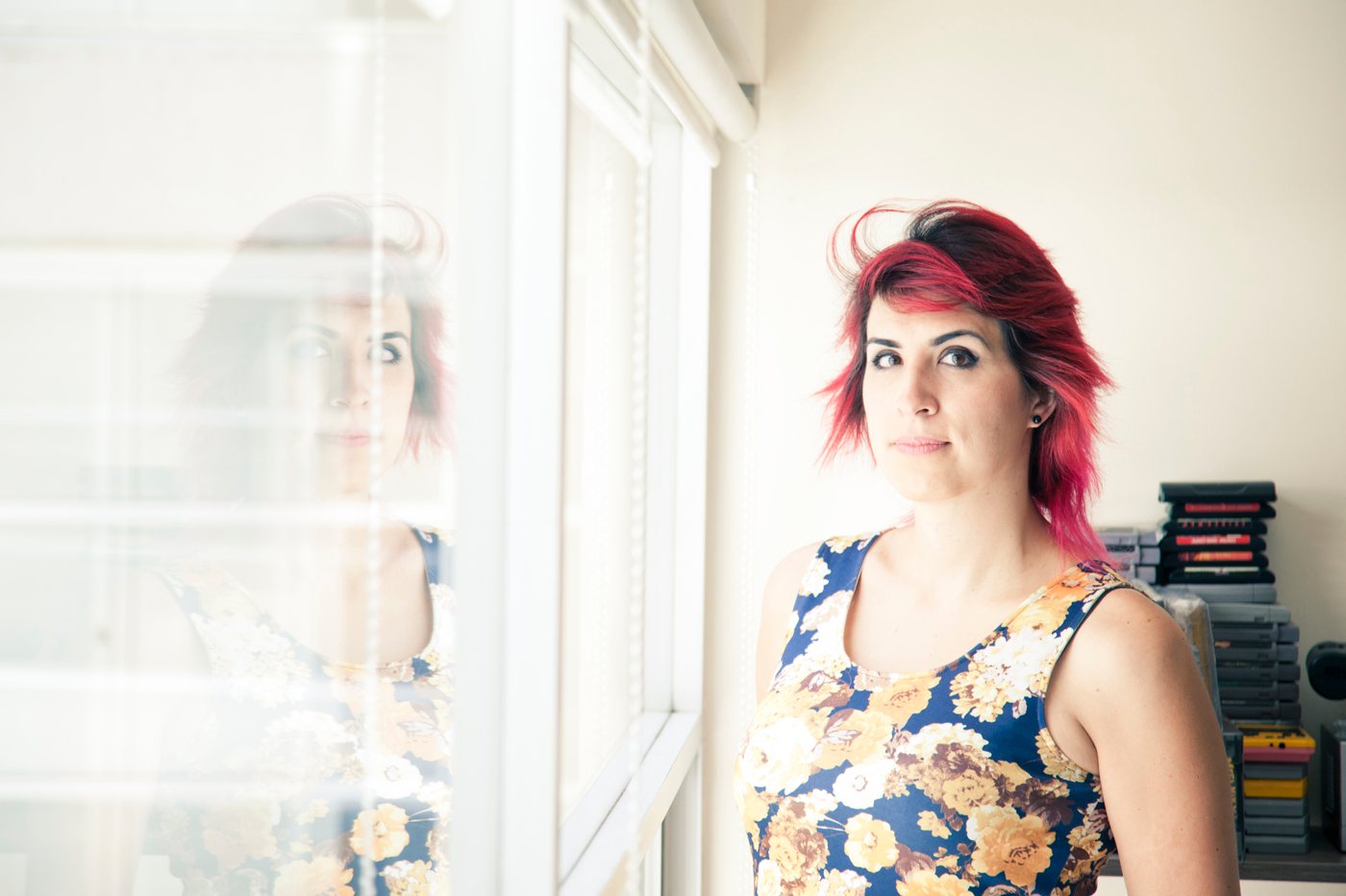 Ophelia con pelo rojo junto a una ventana, vestido floreado. Horizontal.